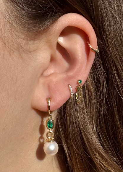 Person wearing Howl fine jewelry 18k yellow gold Emma Pearl and Emerald Earrings