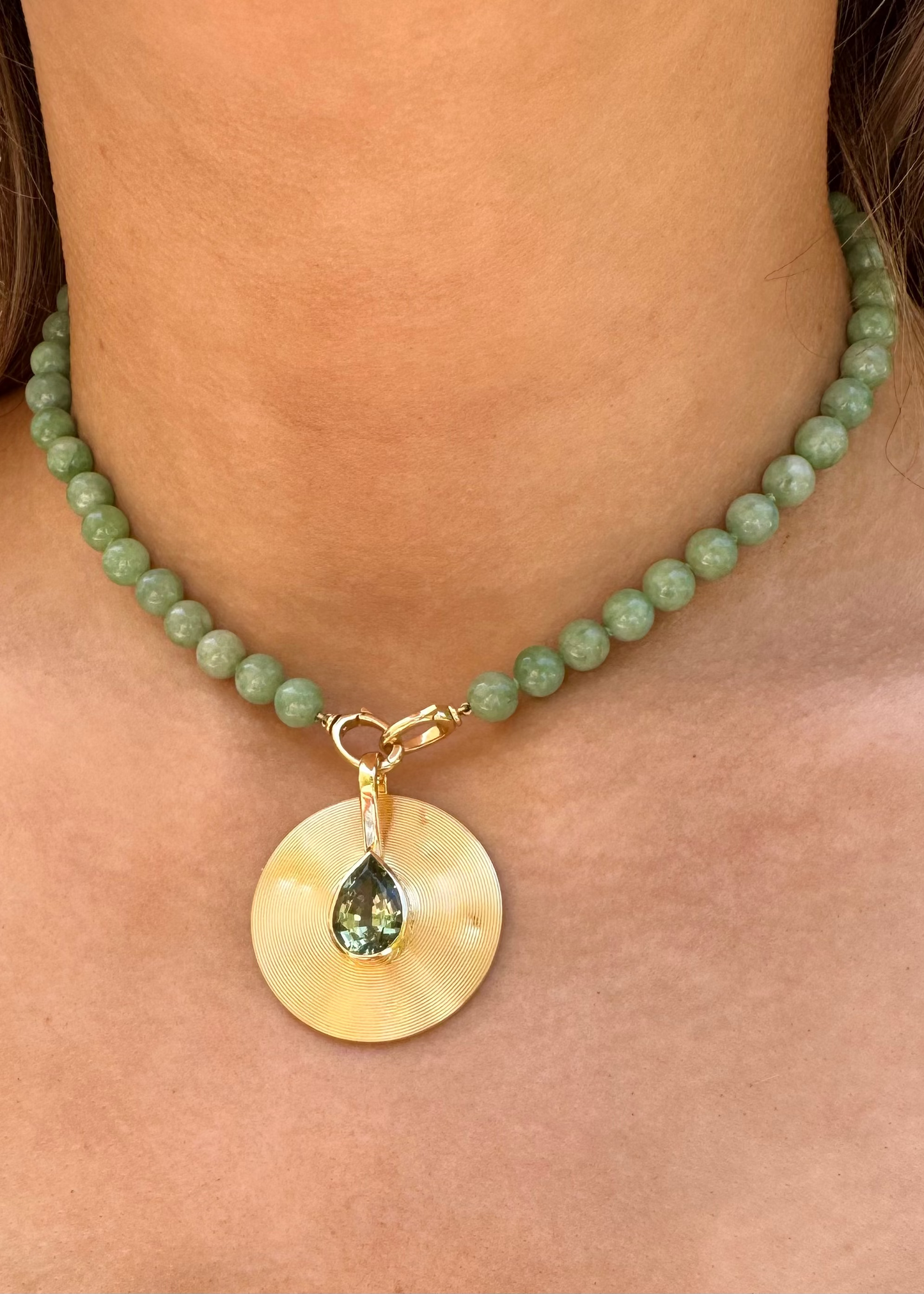 person wearing JADE RUZZO fine jewelry 18k yellow gold One-of-a-Kind Medium Cymbal Pendant with Mint Tourmaline Pear