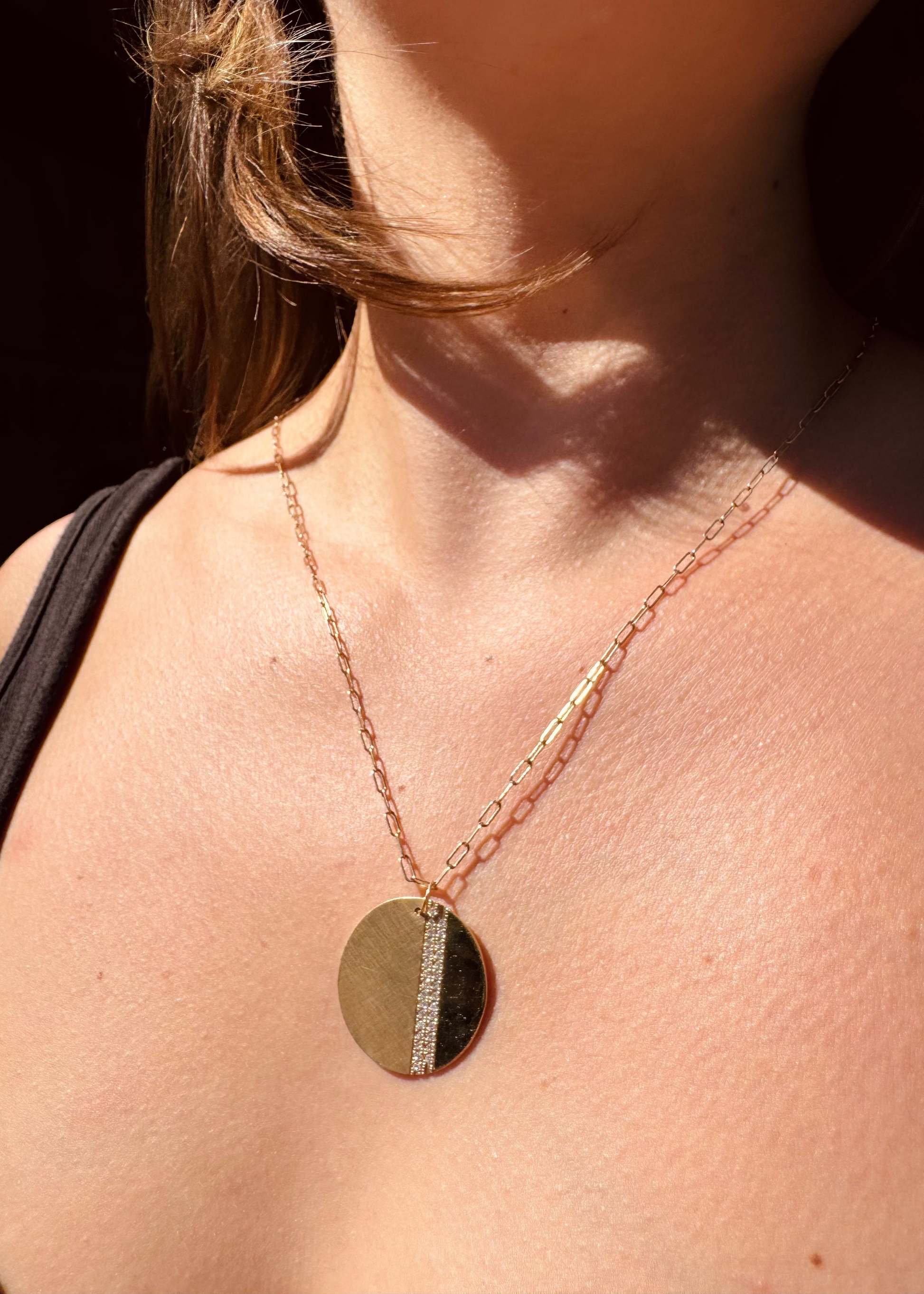 Person wearing Julez Bryant 14k yellow gold diamond Joma Pendant Necklace