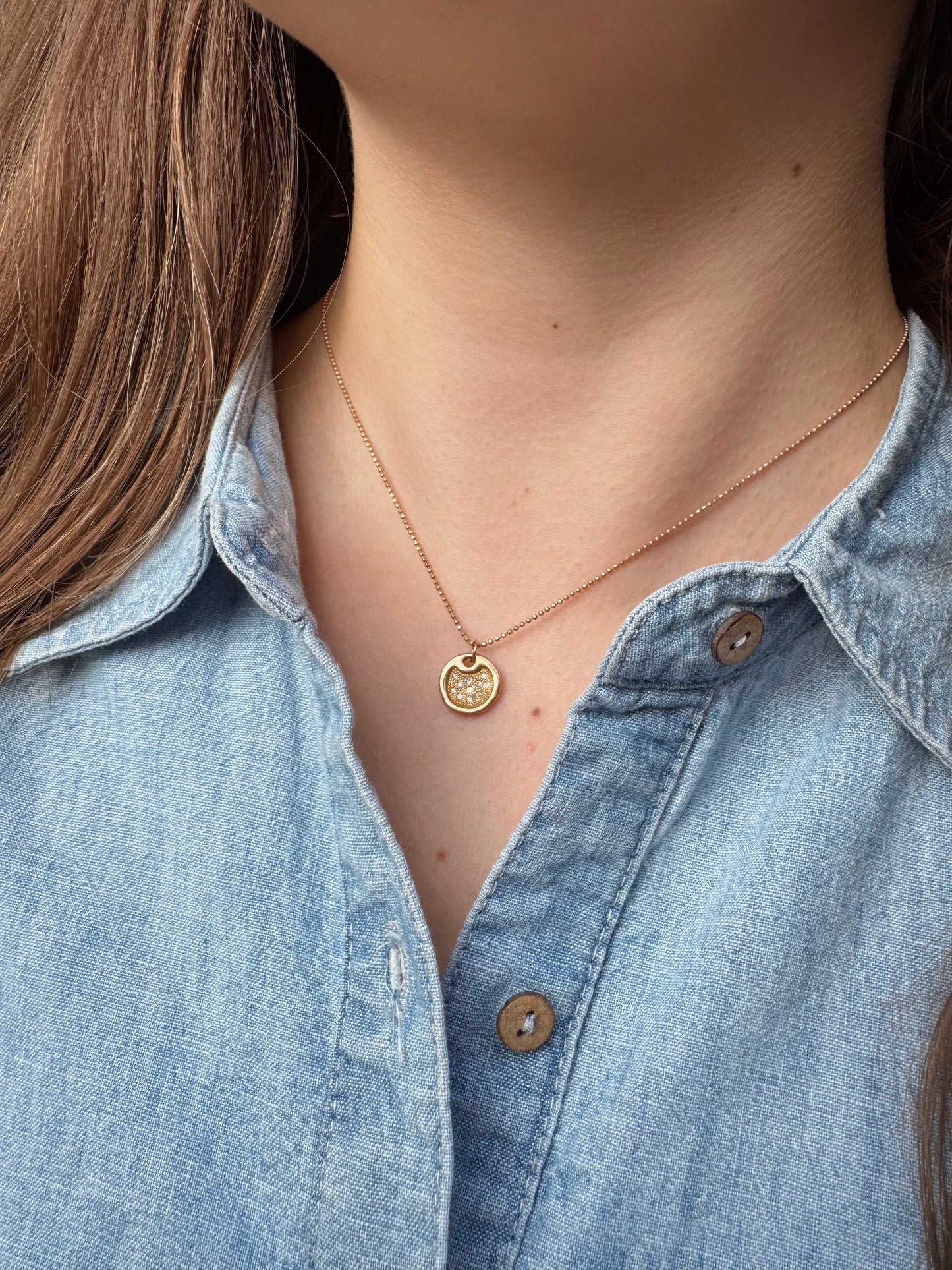 Person wearing Julez Bryant fine jewelry 14k rose gold 1mm Diamond Cut Ball Chain with Dena 14k Baby Round Dog Tag with Diamonds