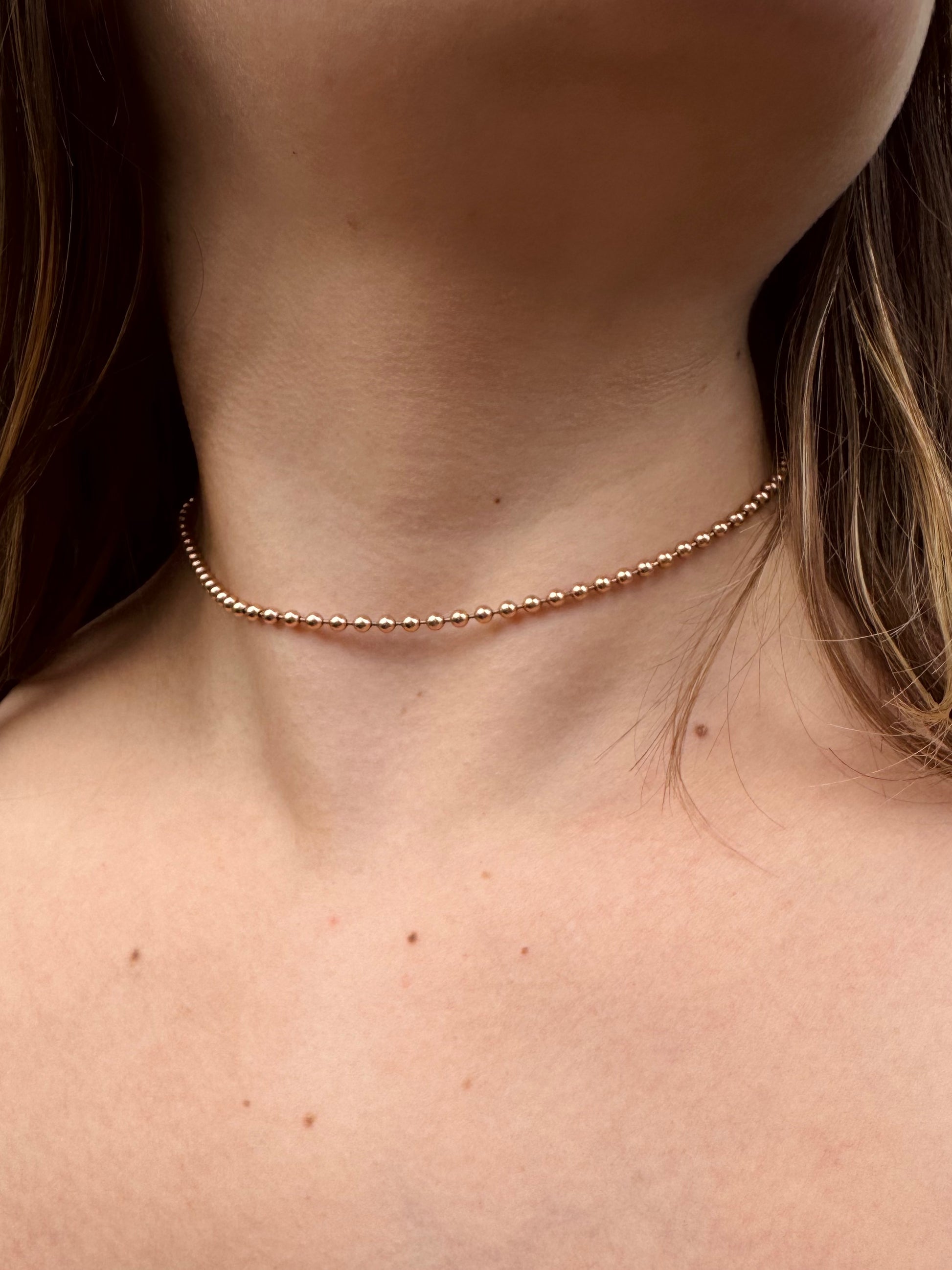 Person wearing Julez Bryant fine jewelry 14k rose gold 2mm Ball Chain Necklace