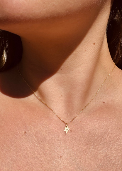Person wearing Julez Bryant fine jewelry 14k yellow gold diamond Teeny Tiny Spark Charm Necklace