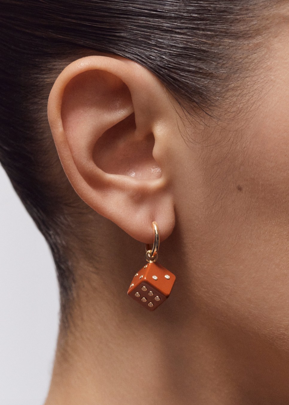 Person wearing Marie Lichtenberg fine jewelry 18k yellow gold Jasper Dado Pendant Earring Charm