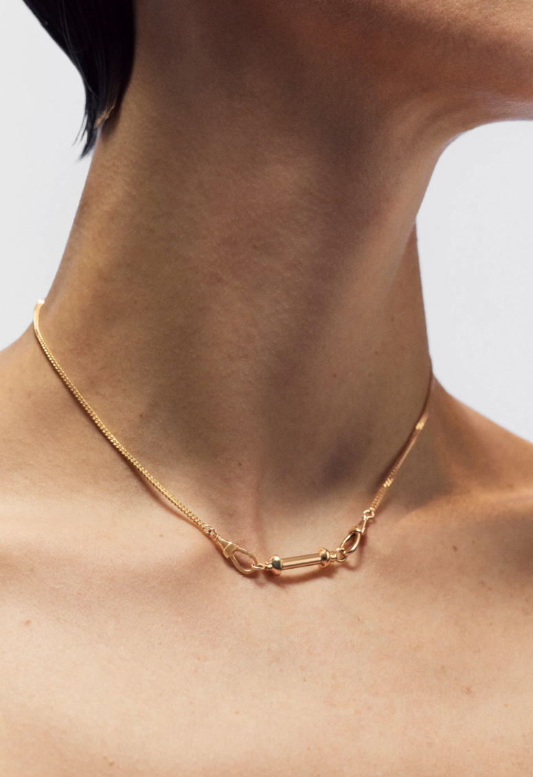Person wearing Marie Lichtenberg fine jewelry 18k yellow gold Small Connector Stick Pendant on Gourmette chain