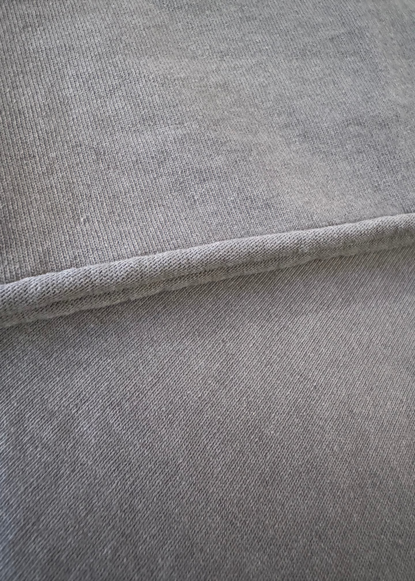 Details of Monostereo Cotton "On the Farm" Raw Hem Tee in Washed Black