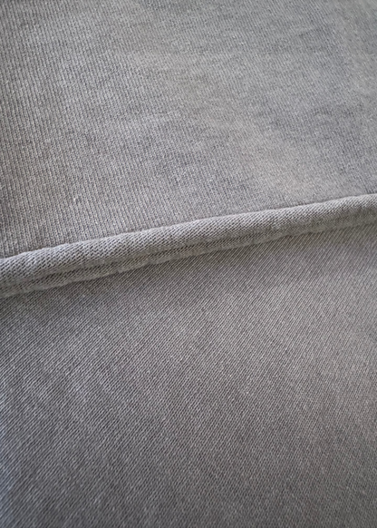 Details of Monostereo Cotton "On the Farm" Raw Hem Tee in Washed Black