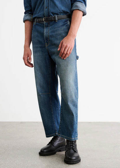 Person wearing Nili Lotan Men's Carpenter Jean in Classic Wash