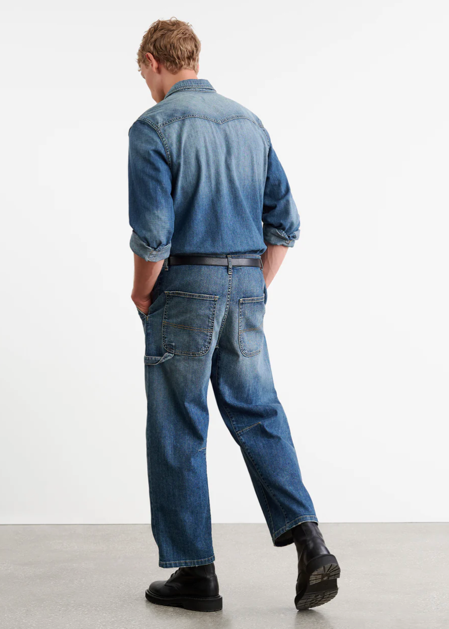 Person wearing Nili Lotan Men's Carpenter Jean in Classic Wash