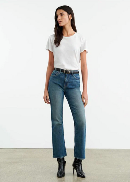 Person wearing Nili Lotan womens denim Boot Cut Jean in Classic Wash