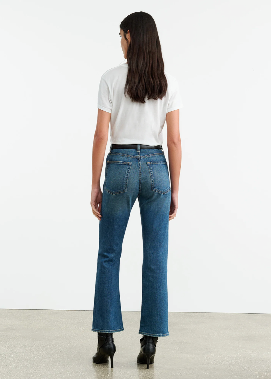 Person wearing Nili Lotan womens denim Boot Cut Jean in Classic Wash