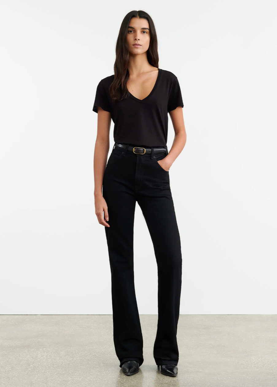 Person wearing Nili Lotan womens denim Joan Jean in Distressed Black