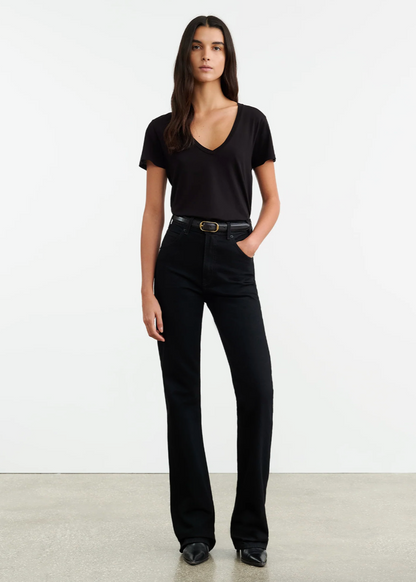 Person wearing Nili Lotan womens denim Joan Jean in Distressed Black