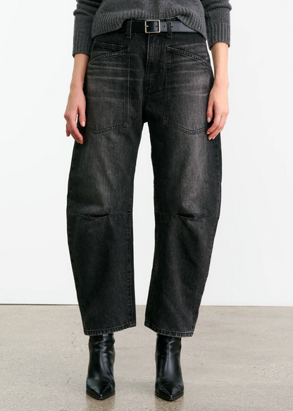 Person wearing Nili Lotan womens denim Shon Jean in Stone Black Wash