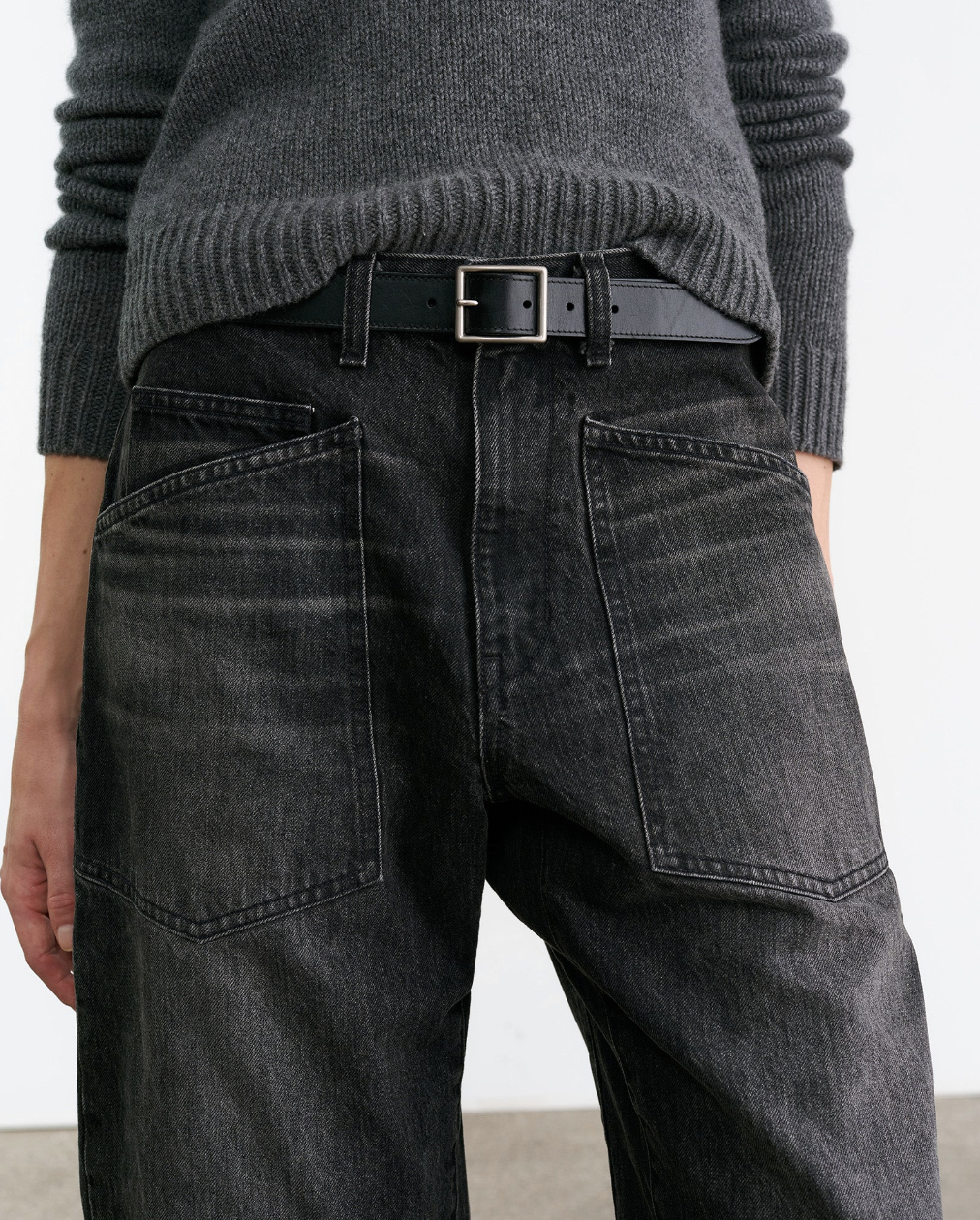 Person wearing Nili Lotan womens denim Shon Jean in Stone Black Wash
