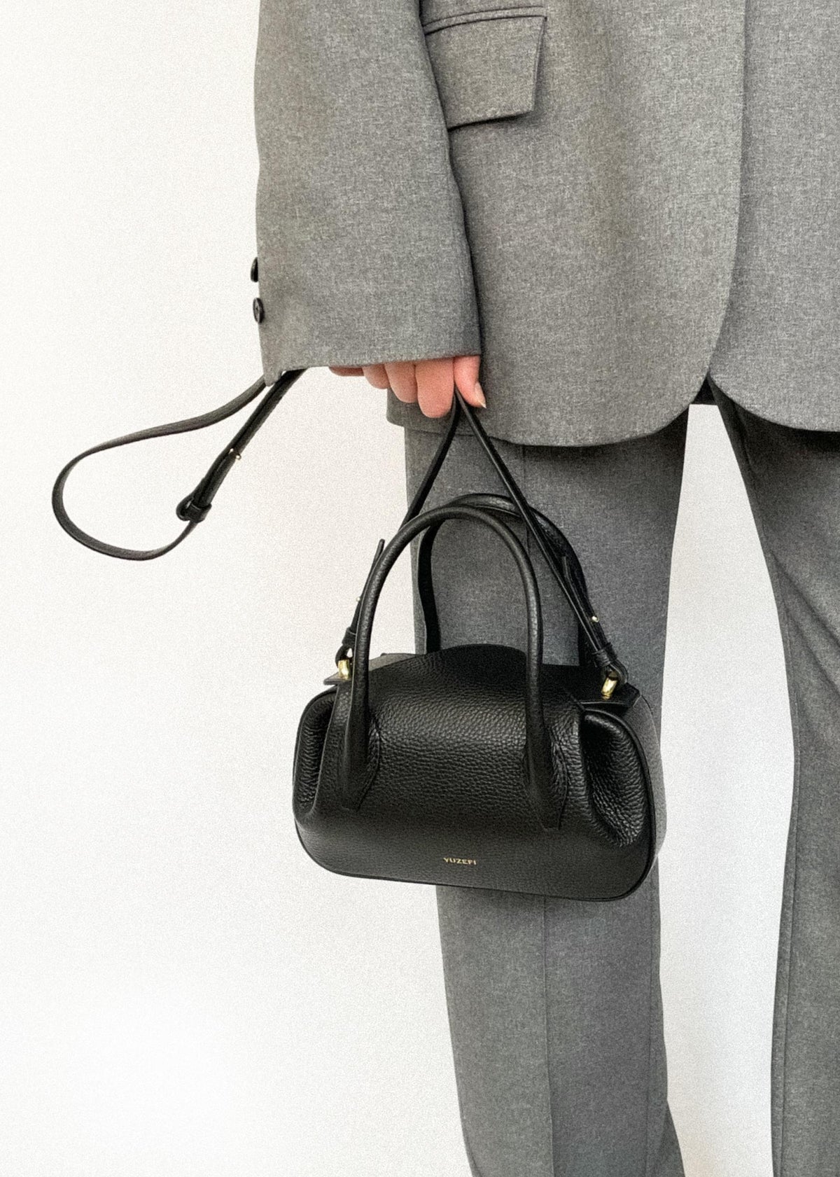 person wearing Oyster Mini Duffle in Black Pebble Grained Leather