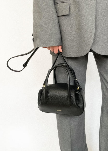 person wearing Oyster Mini Duffle in Black Pebble Grained Leather