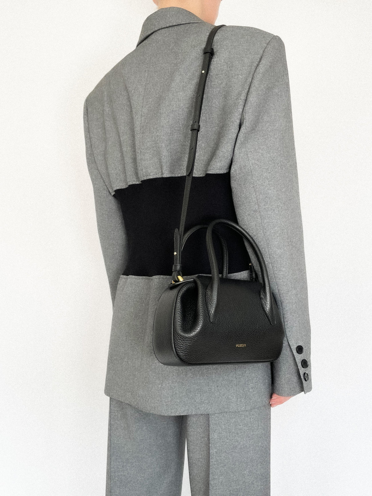 person wearing Oyster Mini Duffle in Black Pebble Grained Leather