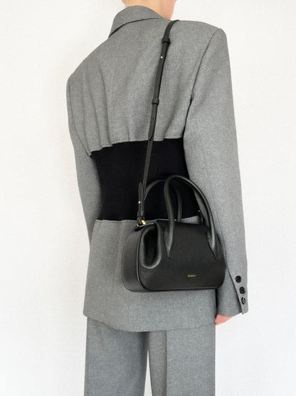 person wearing Oyster Mini Duffle in Black Pebble Grained Leather