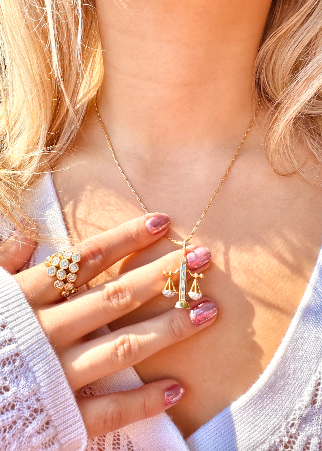Person wearing Brent Neale fine jewelry 18k yellow gold diamond Medium Zodiac Libra Pendant Necklace and Diamond Pyramid Ring