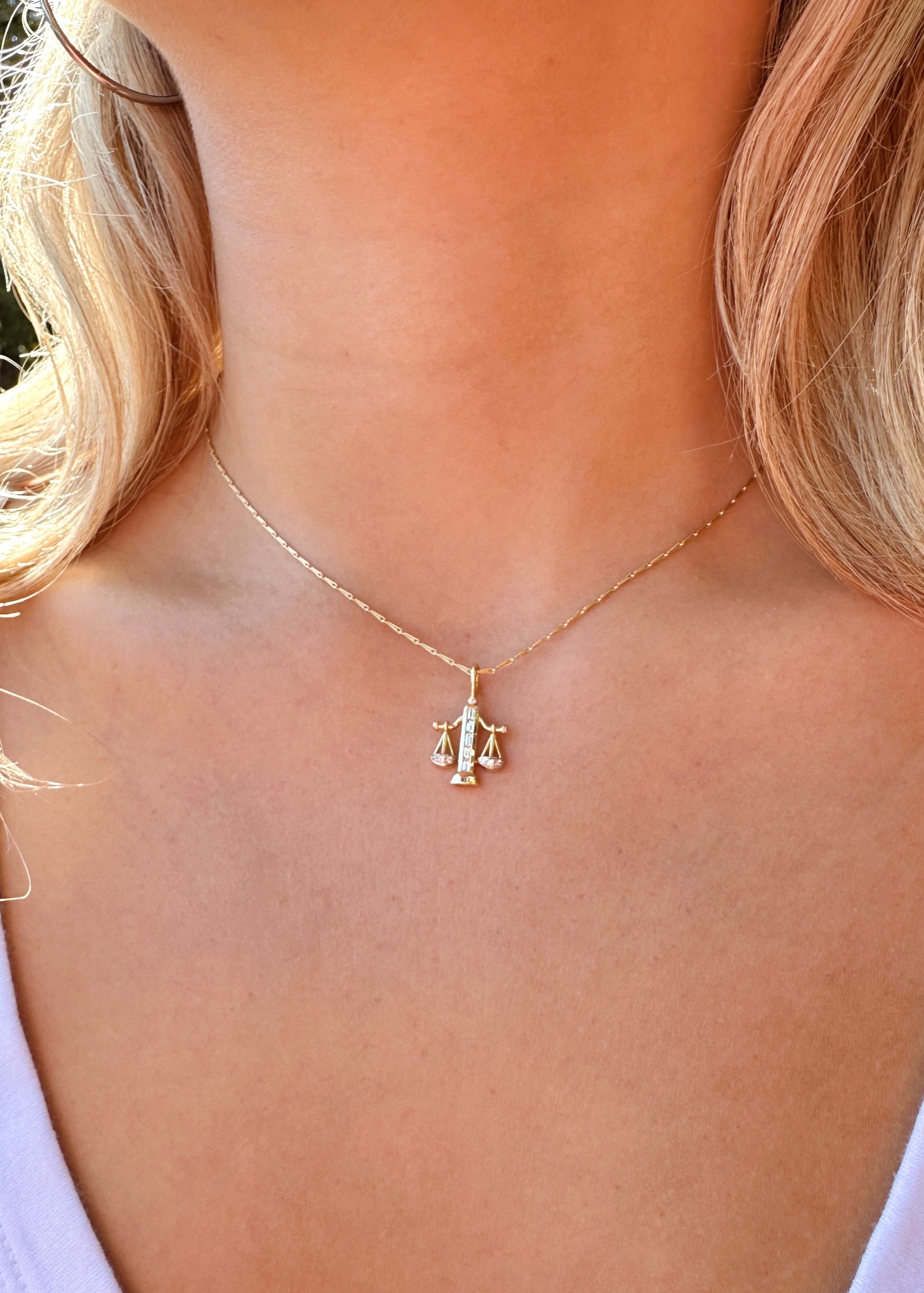 Person wearing Brent Neale fine jewelry 18k yellow gold diamond Small Libra Zodiac Pendant Necklace