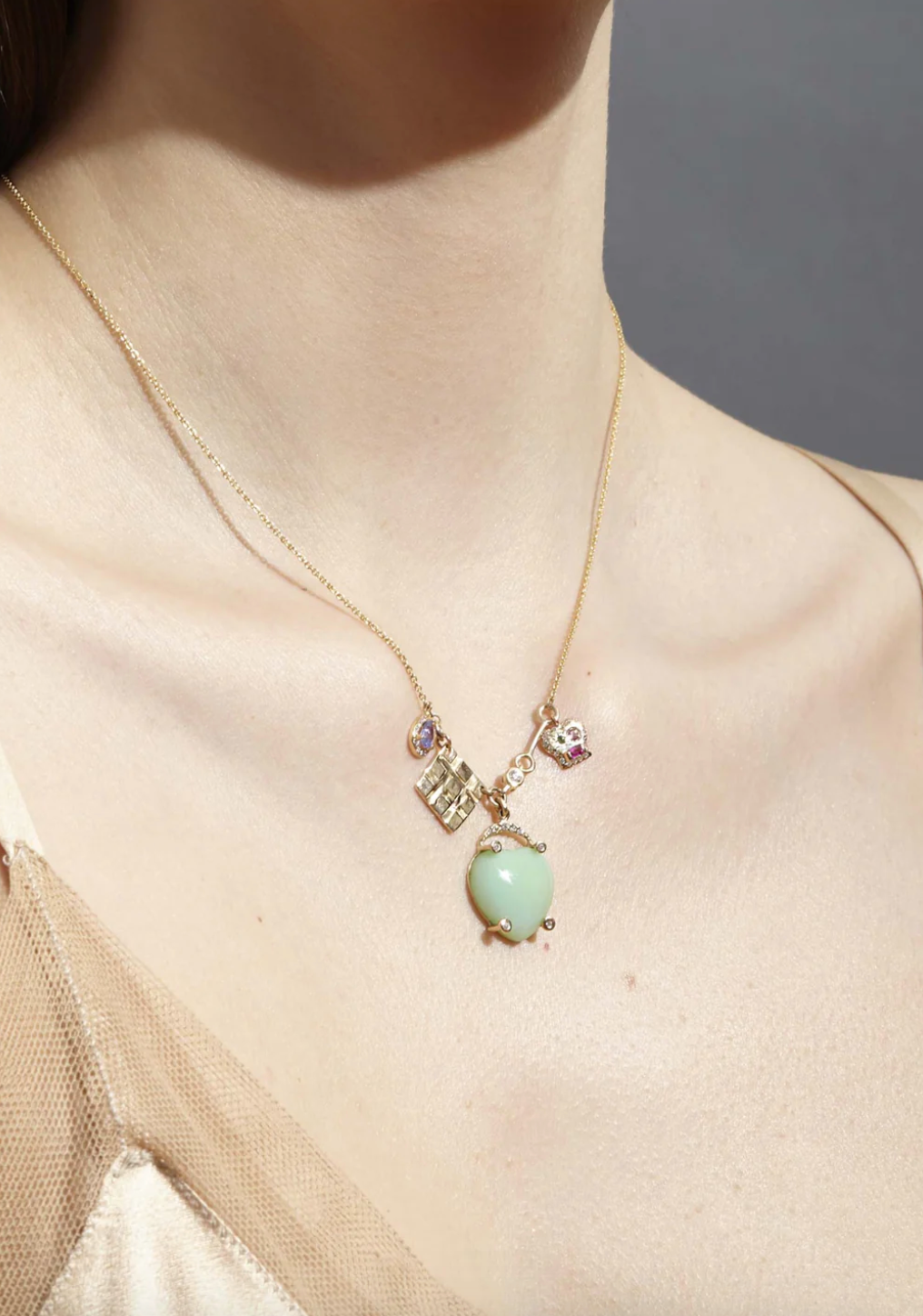 Person wearing SCOSHA Fine Jewelry 14k yellow gold The Lucky Heart Charm Necklace
