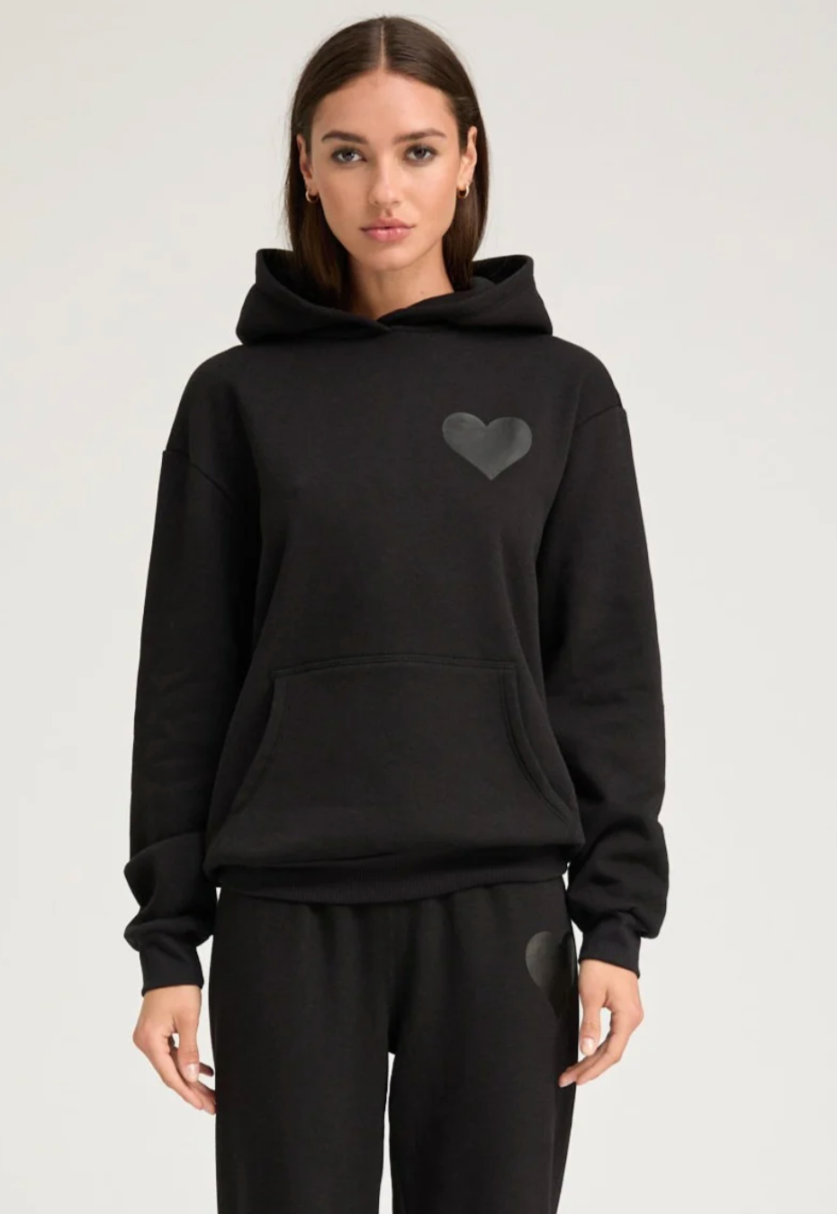 Person wearing SPRWMN Heart Hoodie in Black Gloss