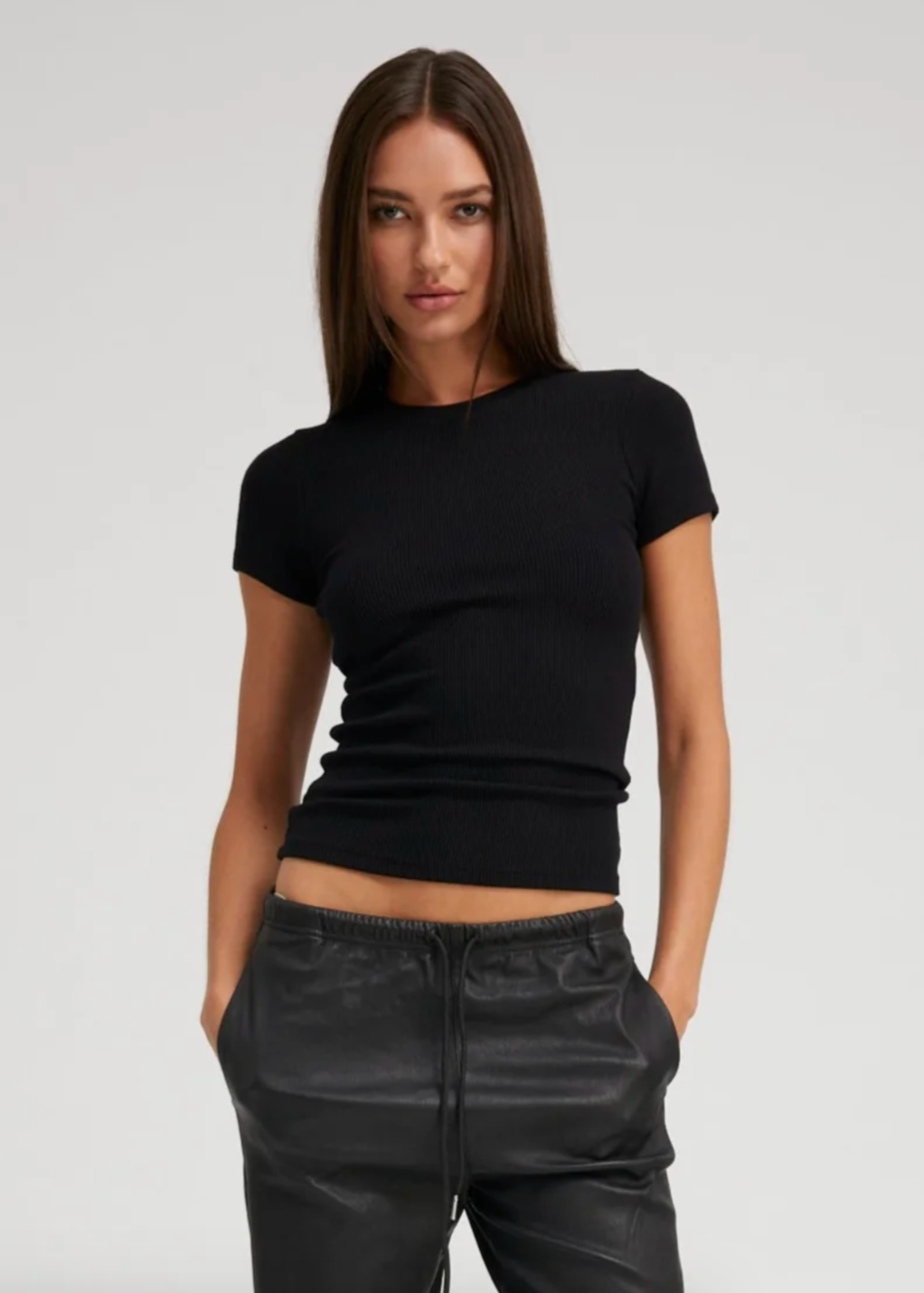 Person wearing SPRWMN Rib Baby Tee in Black