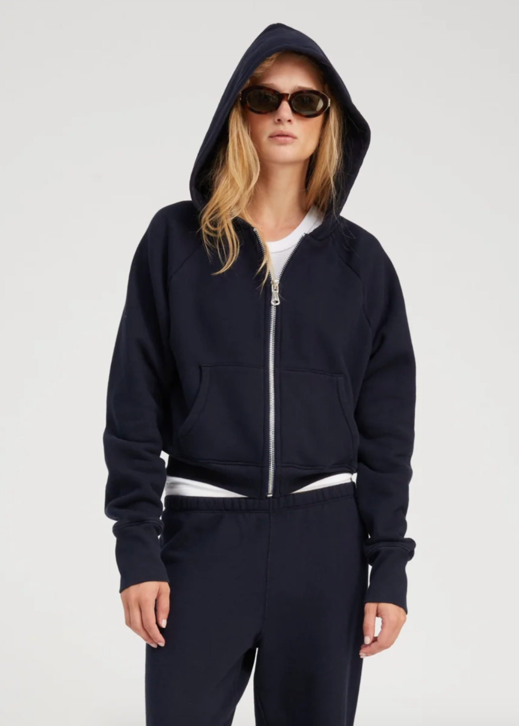 Person wearing SPRWMN Shrunken Zip Up Hoodie in Navy