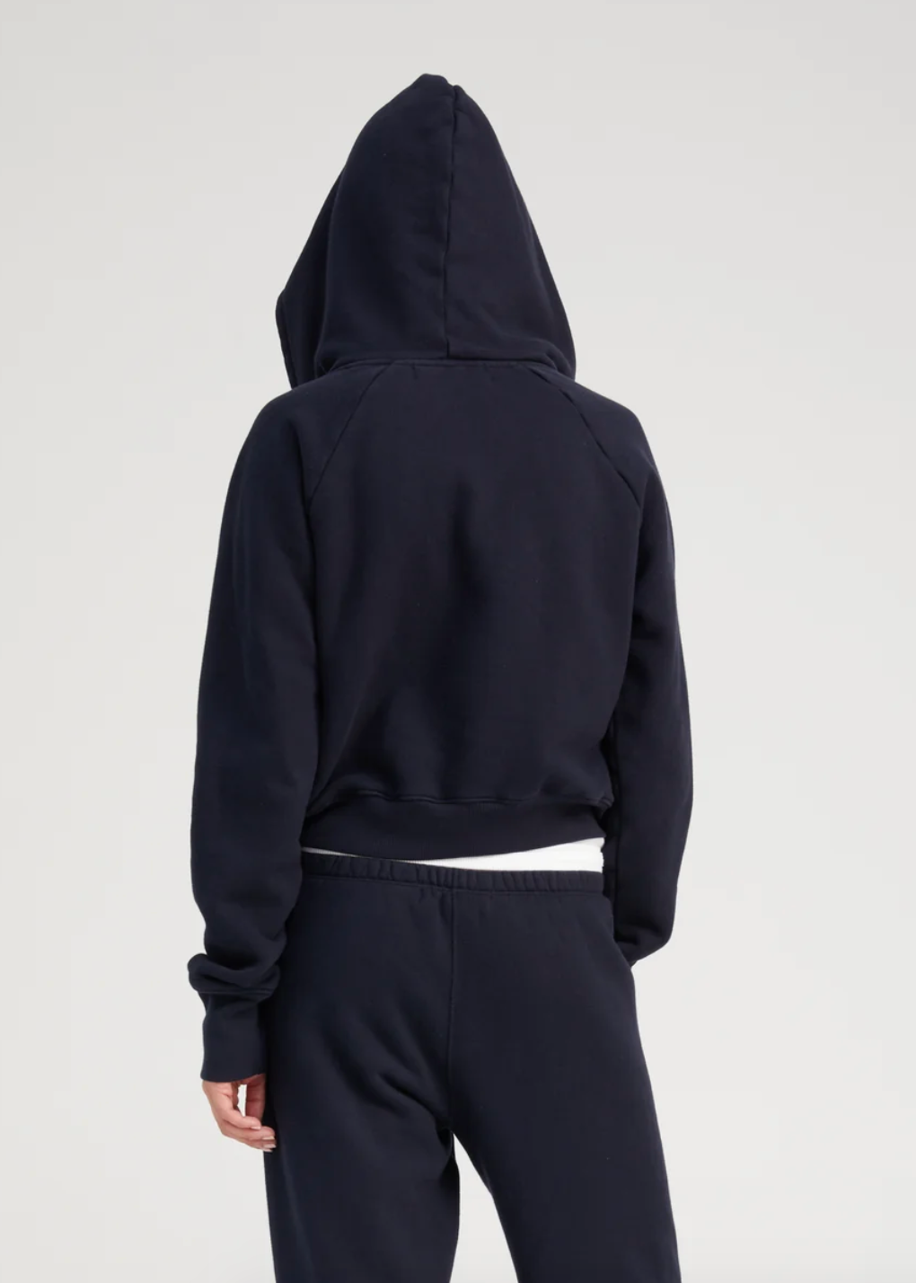 Person wearing SPRWMN Shrunken Zip Up Hoodie in Navy