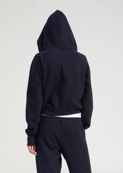 Person wearing SPRWMN Shrunken Zip Up Hoodie in Navy