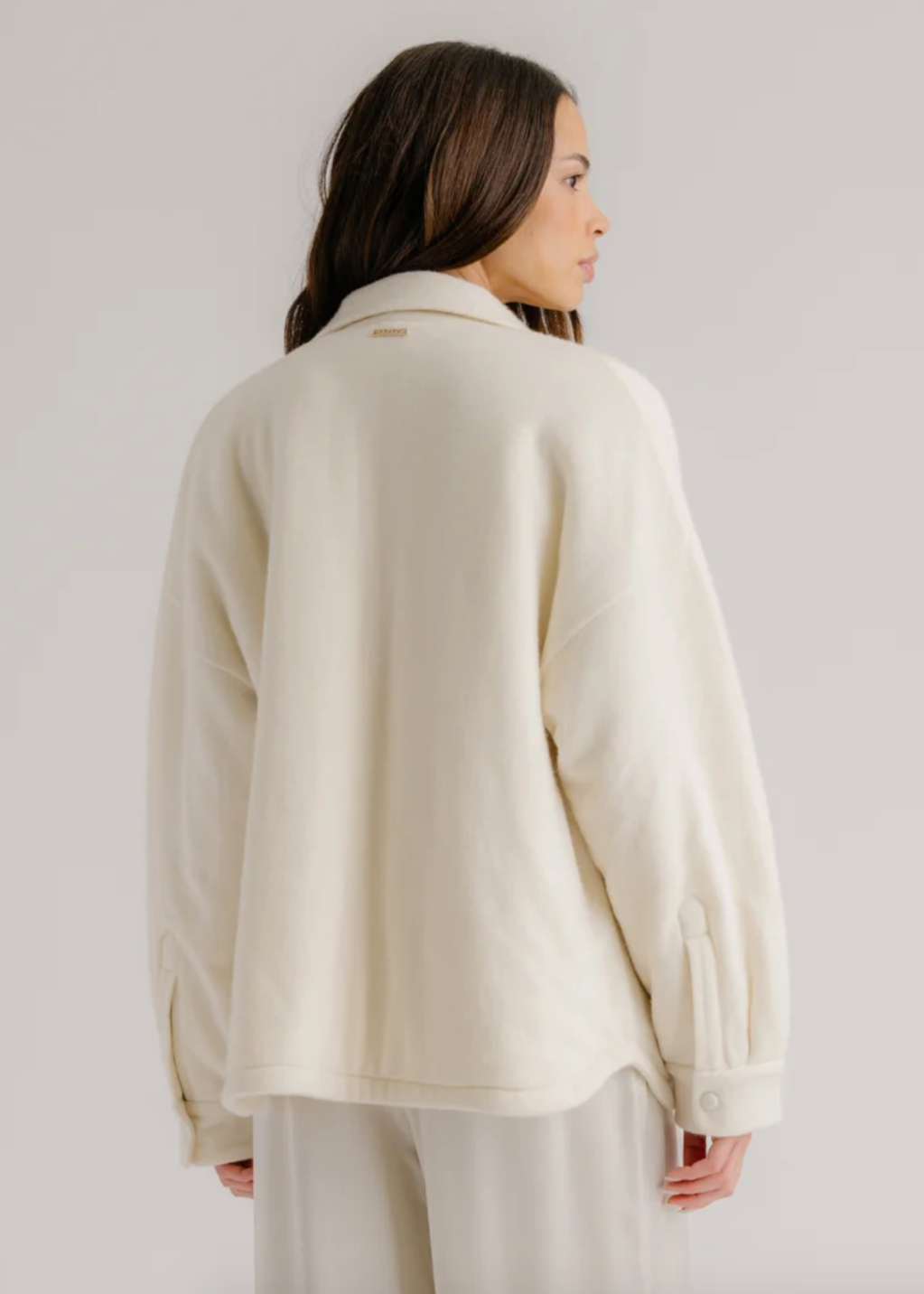 Person wearing Sablyn womens cashmere Izzy Filled Relaxed Shirt Jacket in Gardenia