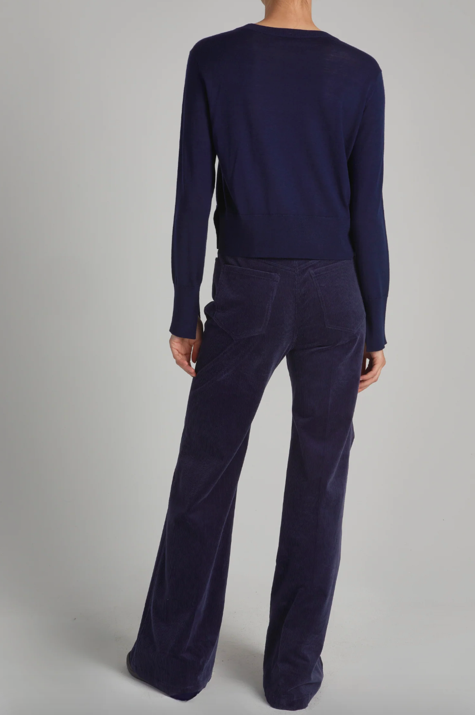 Person wearing Saint Art womens Aron Corduroy Flared Pants in Navy
