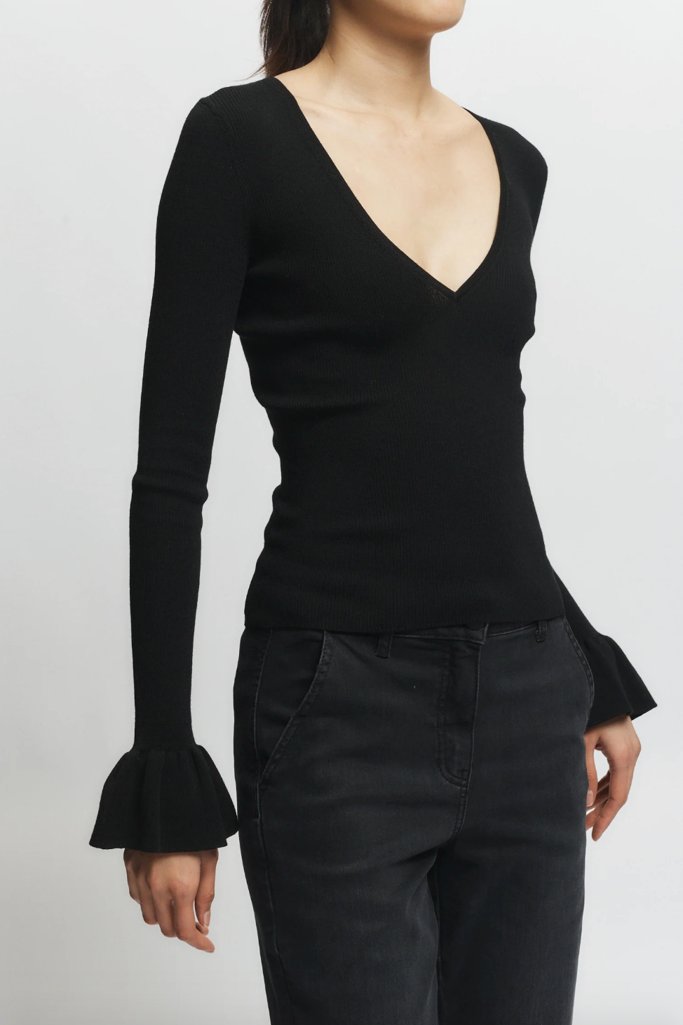 Person wearing Saint Art womens Watson Ruffle Knit Sweater Black