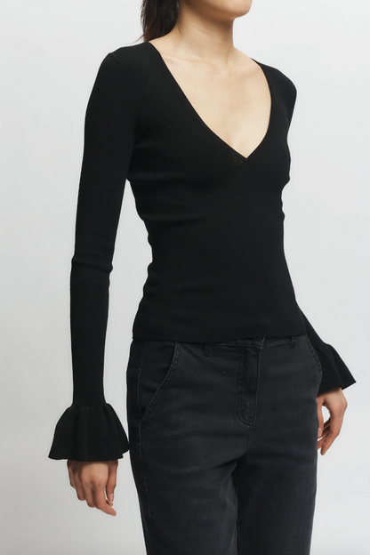 Person wearing Saint Art womens Watson Ruffle Knit Sweater Black
