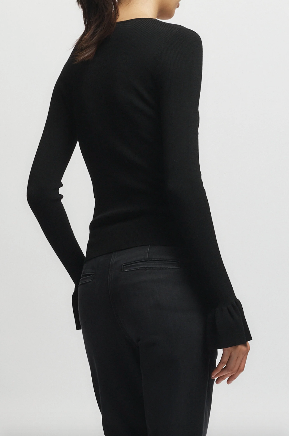 Person wearing Saint Art womens Watson Ruffle Knit Sweater Black