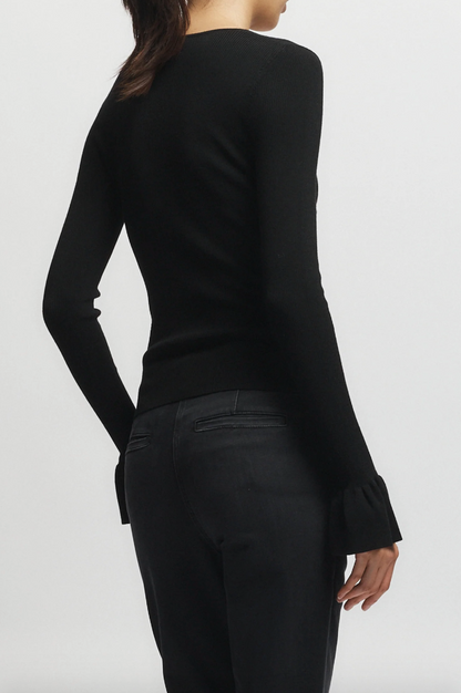 Person wearing Saint Art womens Watson Ruffle Knit Sweater Black