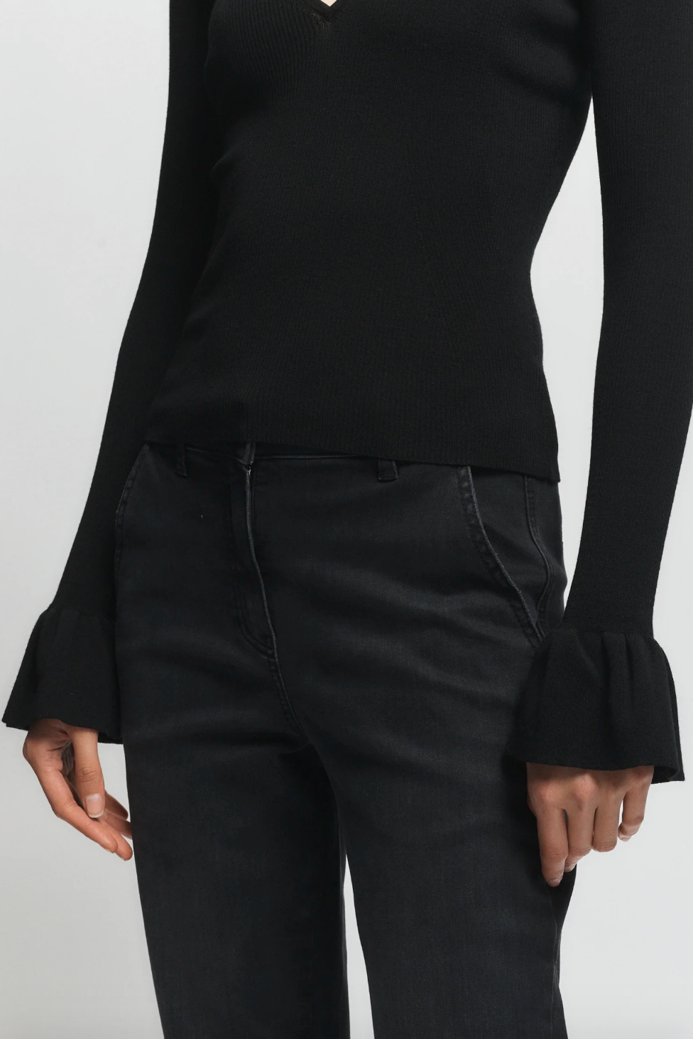 Person wearing Saint Art womens Watson Ruffle Knit Sweater Black