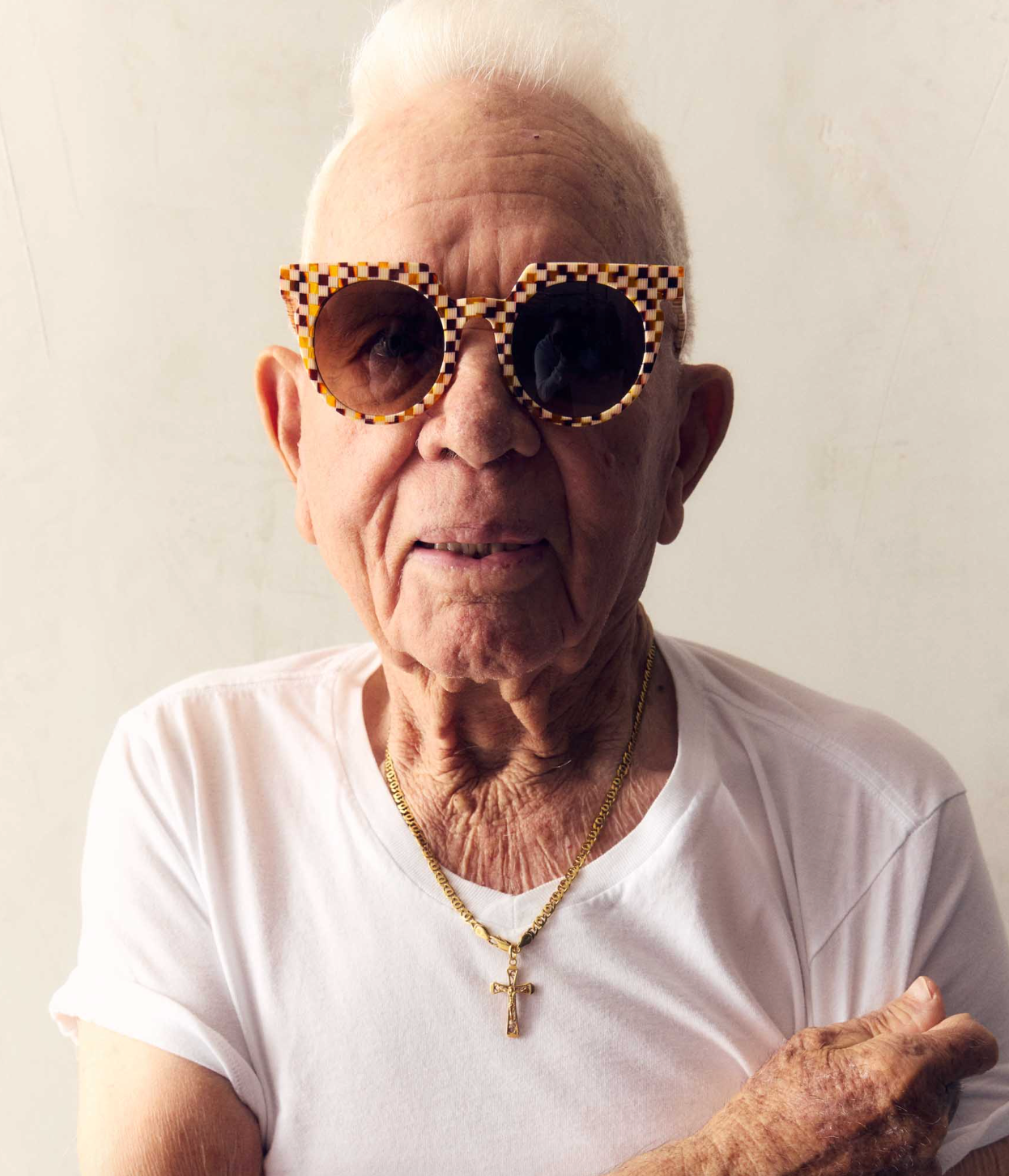 Person wearing Sardine Sunglasses The Aster in Toasted Moxie Checker