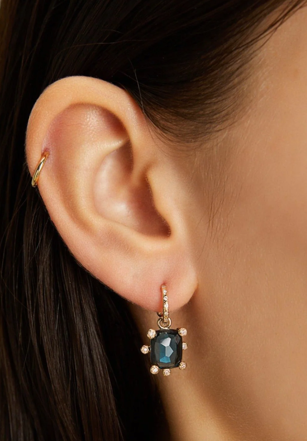 Person wearing Scosha Fine jewelry 14k yellow gold Genie Charm with Blue Topaz and Diamonds