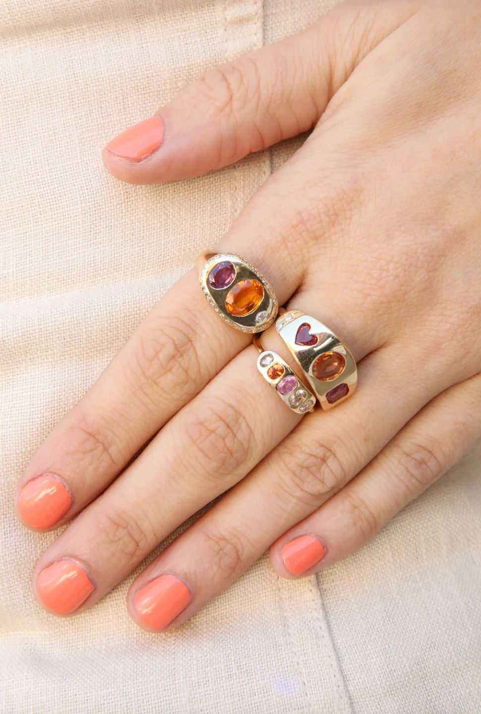 Person wearing Scosha fine jewelry 14k yellow gold Nandi Ring with Orange Garnet and Tourmaline