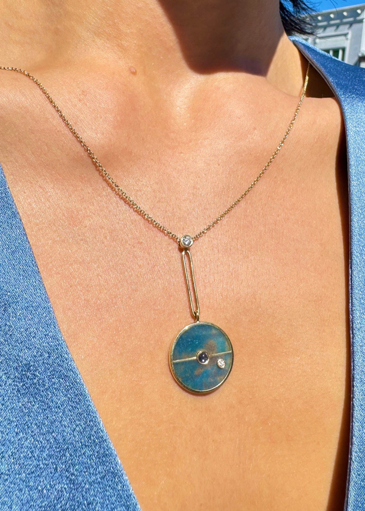 Person wearing Signature Compass Necklace with Trolleite and Tanzanite