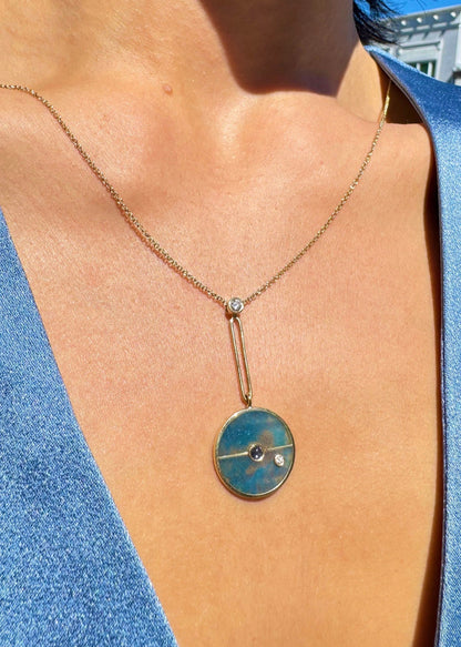Person wearing Signature Compass Necklace with Trolleite and Tanzanite
