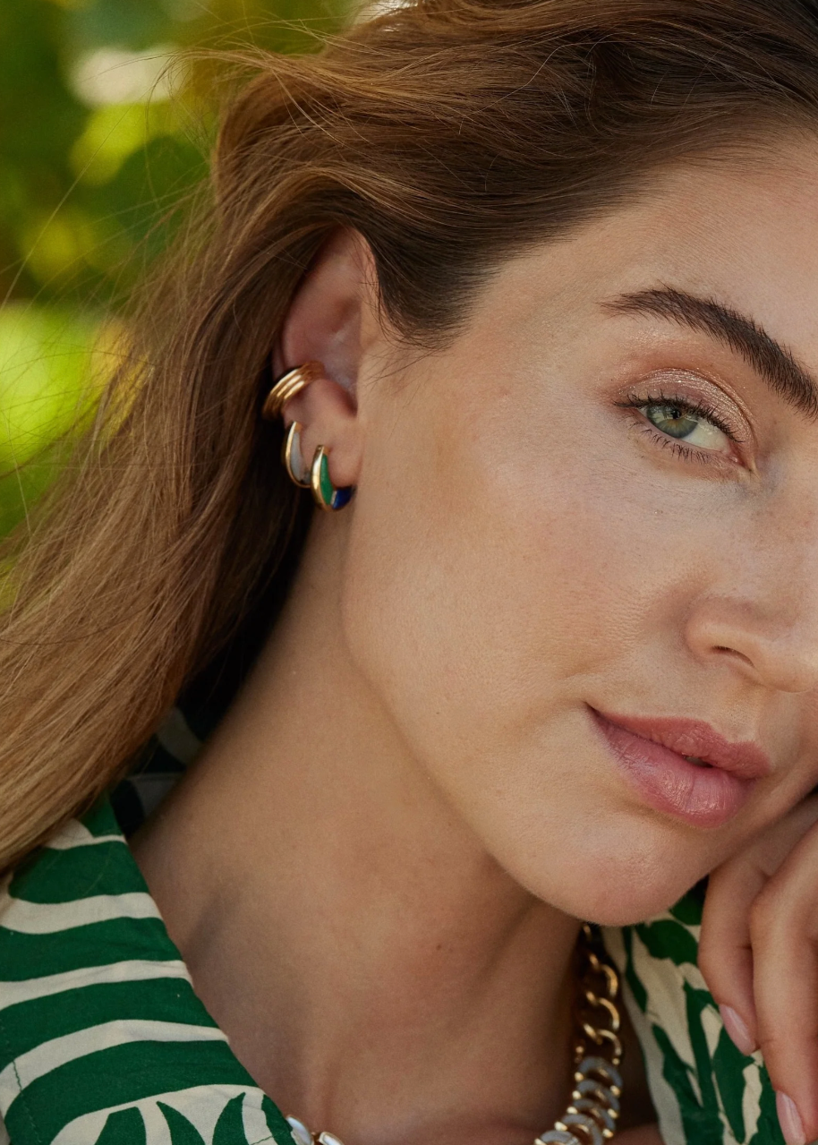 Person wearing Sorellina Fine Jewelry 18k Yellow Gold Capri Inlay Huggies with Mother of Pearl