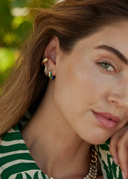 Person wearing Sorellina Fine Jewelry 18k Yellow Gold Capri Inlay Huggies with Mother of Pearl