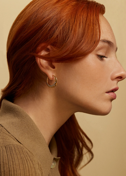 Person wearing Sorellina fine jewelry 18 yellow gold diamond Crown Hoop Earrings