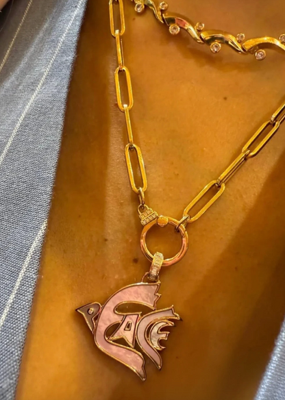 Person wearing Sorellina fine jewelry 18k yellow gold Peace Dove Pendant with Mother of Pearl inlay