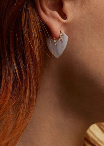 Person wearing Sorellina fine jewelry 18k yellow gold diamond Piccoli Pavé Guitar Pick Earrings with Blue Lace Agate