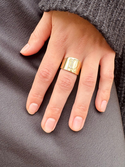 Person wearing The moonstoned fine jewelry womens 14k yellow gold Diamond Initial Cigar Band