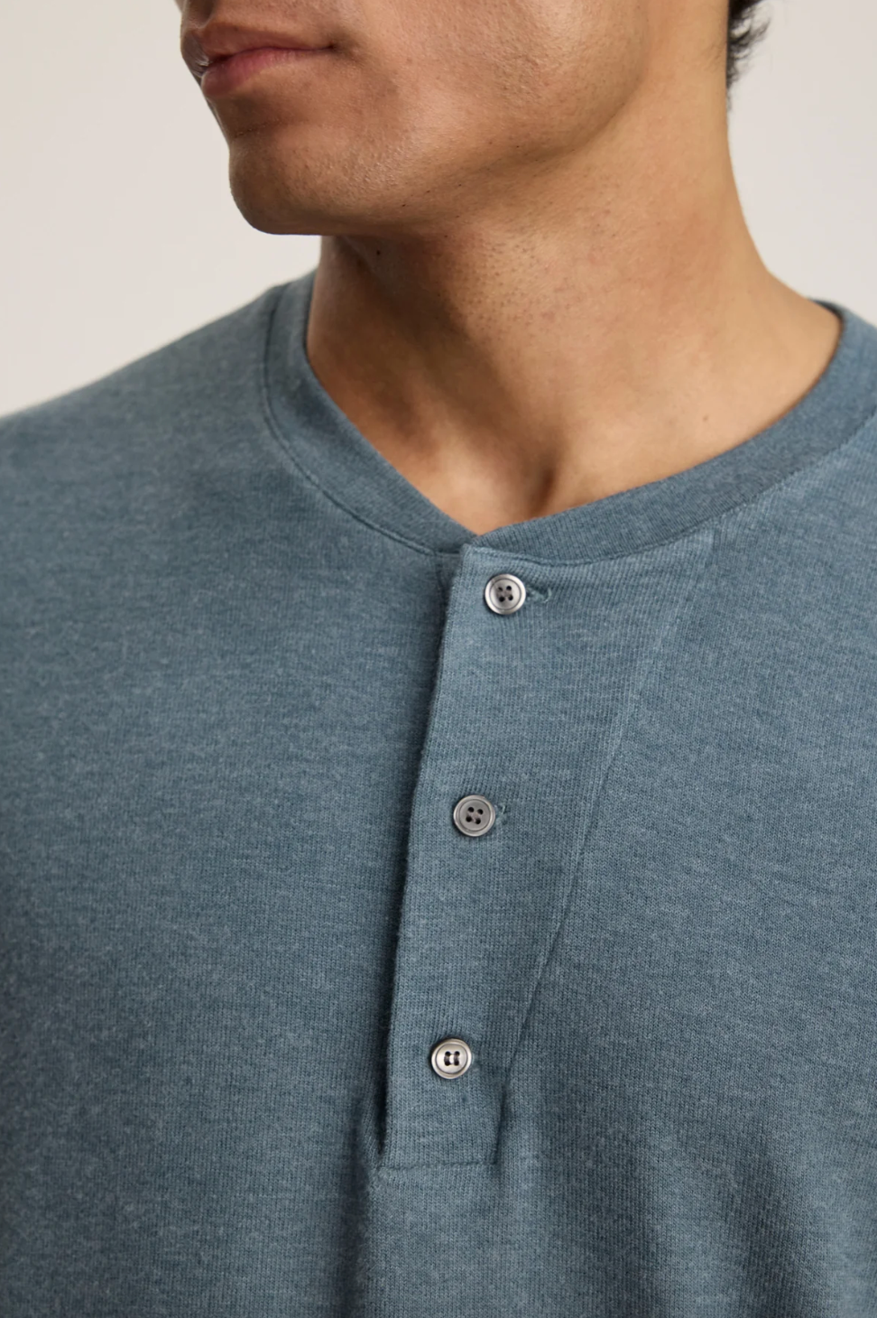 Person wearing Velvet tees mens Ryland Long Sleeve Henley in Anthracite