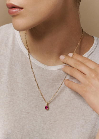 person wearing Viltier fine jewelry 18k yellow gold Talisman Charm with Rubellite